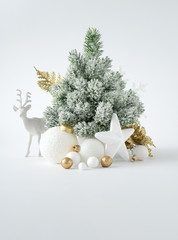 Christmas or New Year layout with white snowy Christmas tree and golden Christmas decoration....