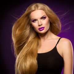 Fototapeta premium Beautiful woman long curly blond hair fashion makeup healthy skin and hair