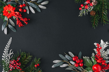 Christmas dark background made of natural winter things. Flat lay border frame with copy space.