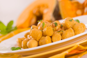 Pumpkin gnocchi with grated amaretti cookies.	