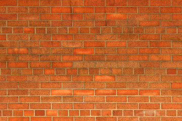 Orange brick wall background texture with different sizes of bricks