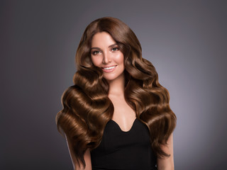 Fototapeta premium Beautiful hair woman long curly hairstyle natural makeup cosmetic concept