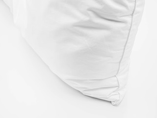 Closeup of white pillow on the bed in the bedroom.
