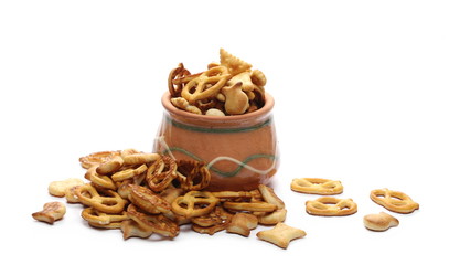 Salty cracker and pretzel snacks, party mix in clay bowl, pot isolated on white background