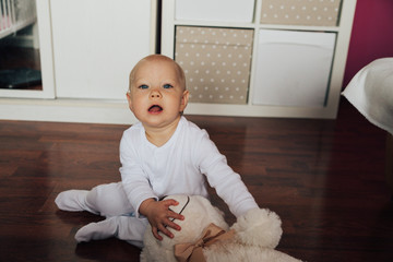 Fototapeta premium baby girl with teddy bear on the floor
