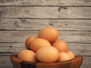 brown egg in wood bowl