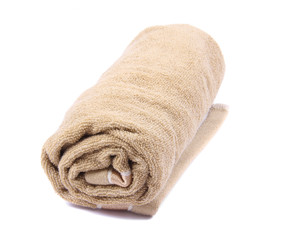A towel rolled up on a white background 