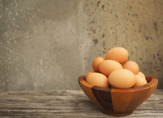 brown egg in wood bowl