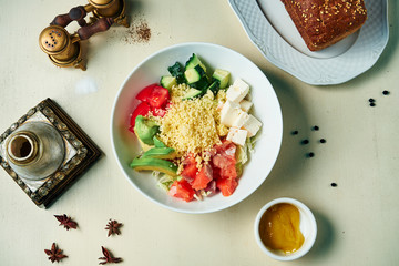 Seafood bowl with avocado, couscous, salmon, tomato. Buddha bowl with healthy and balanced food. Top view, flat lay