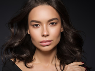 Beautiful asian woman close up face black dress healthy skin natural makeup