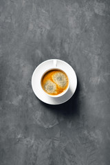 One cup of coffee on a table.