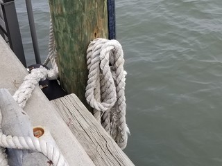 Fototapeta premium rope, boat, knot, ship, sea, sailing, nautical, ropes, water, blue, ocean, line, old, sailboat, marine, wood, tied, yacht, harbor, mooring, sail, rigging, vessel, dock, equipment