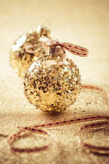 Golden christmas balls on glitter background with copy space