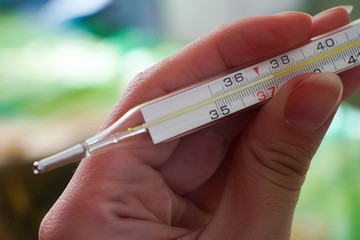 37.5 thermometer in hand, close, illness, flu, infection