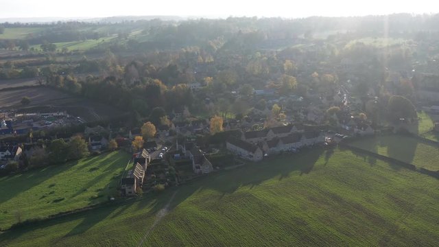 Wide profile slider aerial view of Longborough, a small village near Moreton-In-Marsh in the Cotswolds Area Of Outstanding Natural Beauty, UK