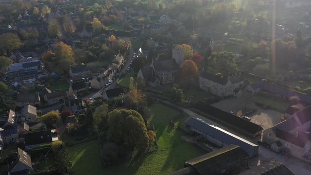 Dolly aerial view of Longborough, push in to St James' church in a small village near Moreton-In-Marsh in the Cotswolds Area Of Outstanding Natural Beauty, UK