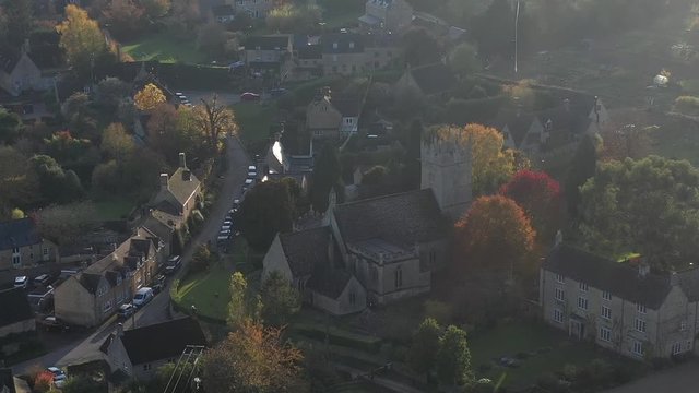 Dolly aerial view of St James' Church in  Longborough, a small village near Moreton-In-Marsh in the Cotswolds Area Of Outstanding Natural Beauty, UK