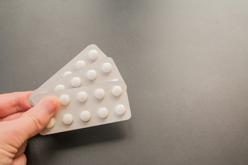 Contraceptive pills pack on black background with copy space