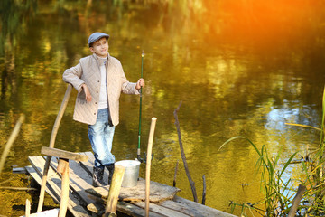 Boy Catching a Fish from wooden dock.