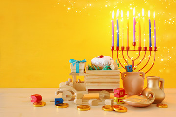 religion image of jewish holiday Hanukkah background with menorah (traditional candelabra), spinning top and doughnut