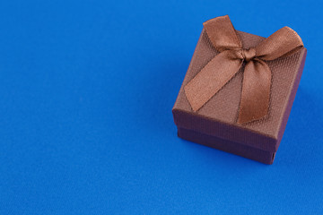 brown gift box on a blue table
