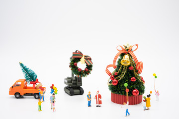 Family Miniature people standing on Christmas tree Celebrate Christmas on December 25 every year. using as background xmas concept with copy spaces for you