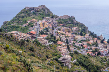 Obraz premium Ruins of Saracen castle in Taormina seen from Castelmola, small town on Sicily Island, Italy