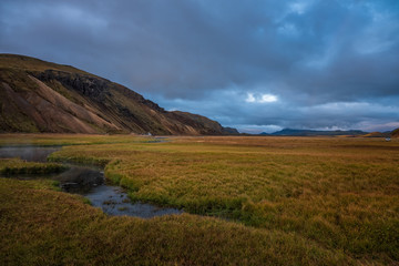 Iceland in september 2019. Great Valley Park Landmannalaugar, surrounded by mountains of rhyolite and unmelted snow. In the valley built large camp. Evening in september 2019