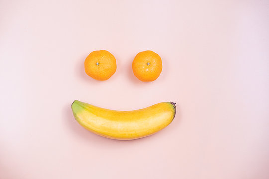 Flat Lay Of Ripe Banana And Two Fresh Oranges Represent A Face Of Smile.