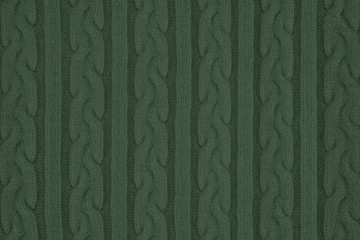 Knitwear Fabric Texture with Pigtails and stripes. Repeating Machine Knitting Texture of Sweater. Dark green Knitted Background.