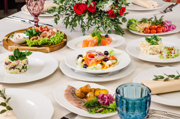 Beautiful restaurant interior table decoration for wedding or event. Flower Wedding Table Decoration, Autumn colors. European food in a restaurant setting. Table set for party.