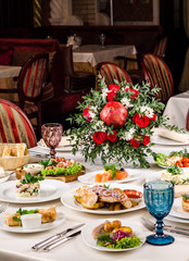 Beautiful restaurant interior table decoration for wedding or event. Flower Wedding Table Decoration, Autumn colors. European food in a restaurant setting. Table set for party.