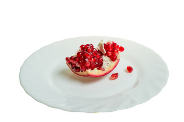 Pomegranate slices and garnet fruit seeds on table. Pomegranate whole. Useful fruit.