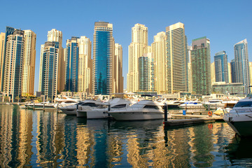 Dubai Marina district with beautiful buildings and yachts. Dubai Marina yachts parking 