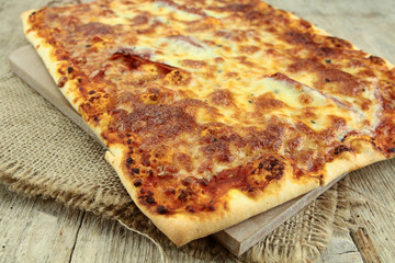 large rectangular pizza lying on a table