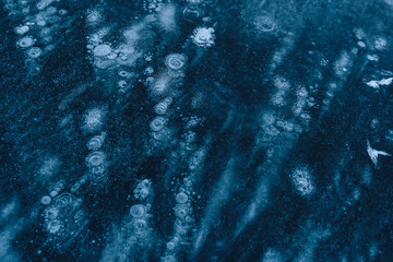  ice texture with frozen air bubbles. winter dark background
