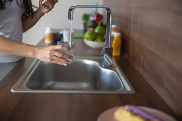 Female hand holding a glass of water