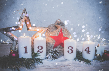 4 white advent candles burning against antique background in christmas decoration