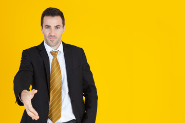Portrait of a handsome adult business man smiling with successful concept on yellow background