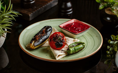grilled vegetables plate with aubergine, pepper, tomato with pomegranate and onion sauce, flatbread