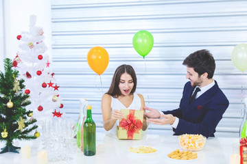 Couple enjoy in romantic party with hapiness face when open gift box celebrating new and christmas party decorated by christmas theme valentine woman day concept.