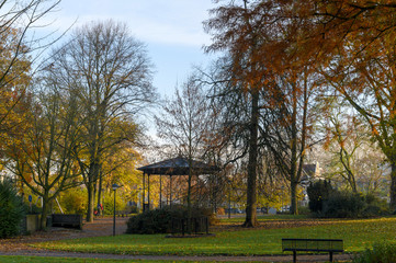 Bandstand in a park among the trees with Indian summer foliage.