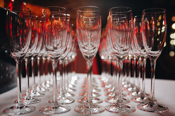 Empty clean champagne glasses on counter in bar.