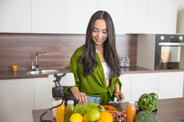 Woman taking a lettuce leaf from the table