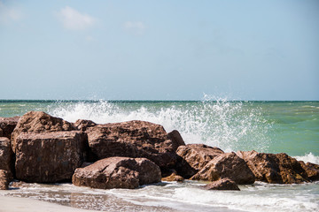 Waves crashing up against the rocks at the ocean