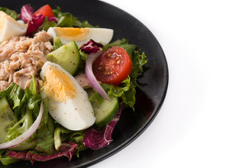 Salad with tuna, egg and vegetables isolated on white background. Copy space	