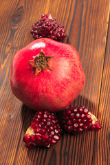 Ripe pomegranate fruit on wooden vintage background. - Image