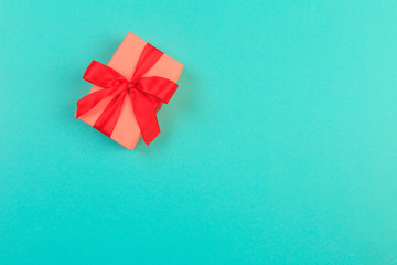 Gift box with ribbon and bow on color background and space for text. Top view - Image