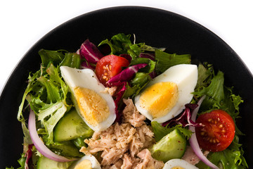Salad with tuna, egg and vegetables isolated on white background.Top view	