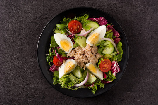 Salad With Tuna, Egg And Vegetables On Black Background